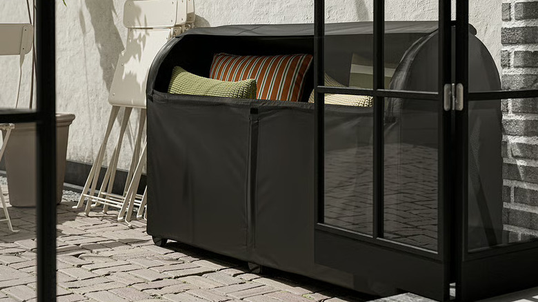 The TOSTERÖ storage box filled with patio furniture cushions