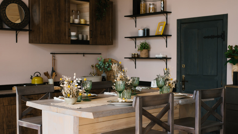 Wooden bar counter with wooden chairs in the interior of the kitchen dining room in the Scandinavian style with decor