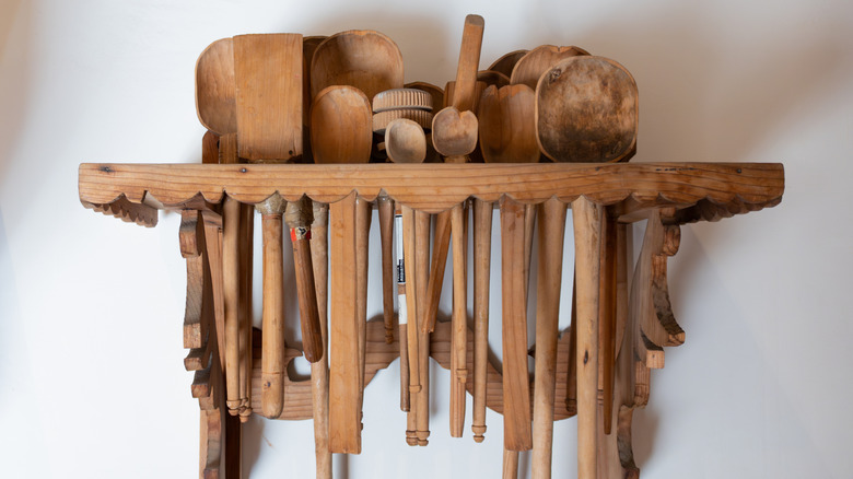 A rack of wooden kitchen utensils