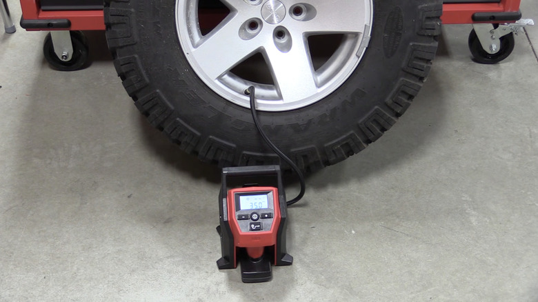 A shot showing the M12 Portable Inflator inflating a car tire