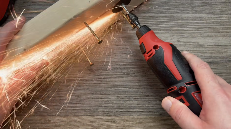 A person cutting off screws with Milwaukee's M12 Rotary Tool