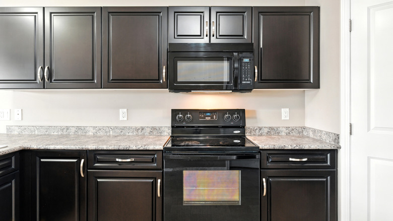 A kitchen with an over-the-stove microwave