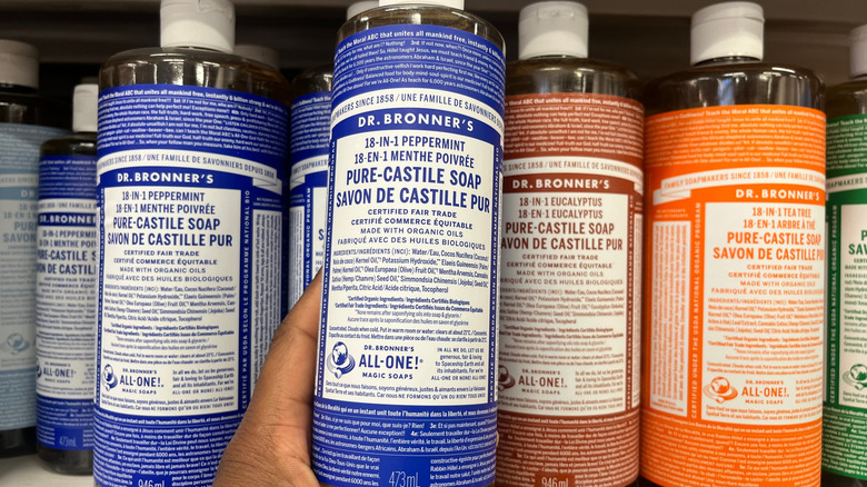 Bottles of Dr. Bronner's castile soap on shelves in a store