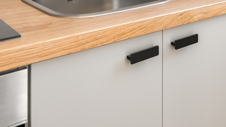 A solid stone backsplash behind a sink