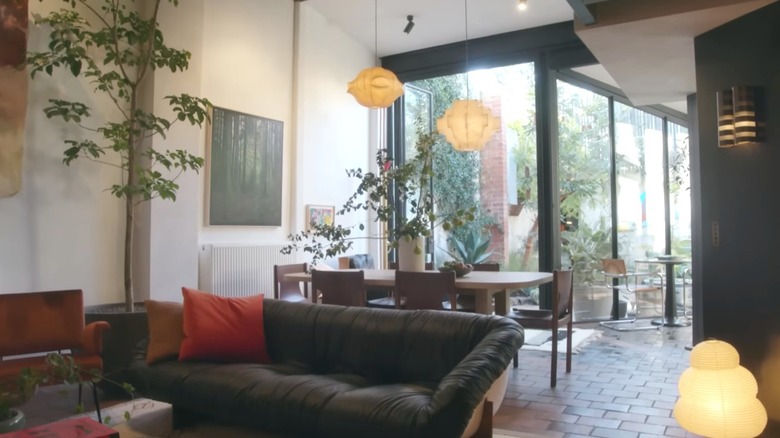 A living room with a black couch.