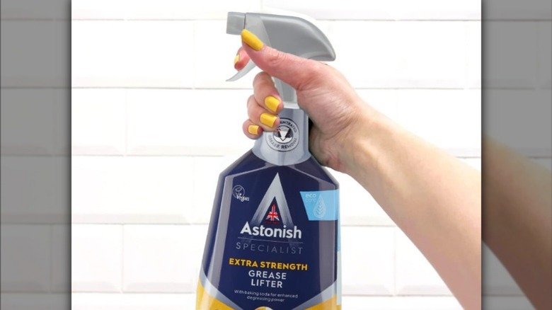 Astonish cleaners sitting on a counter with a cleaning cloth