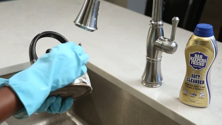 Bar Keeper's Friend being used on a tea kettle