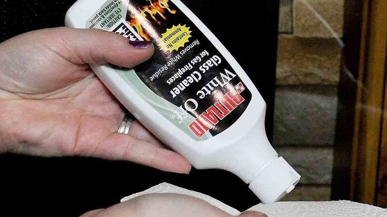 A woman puts Rutland glass cleaner on a white cloth