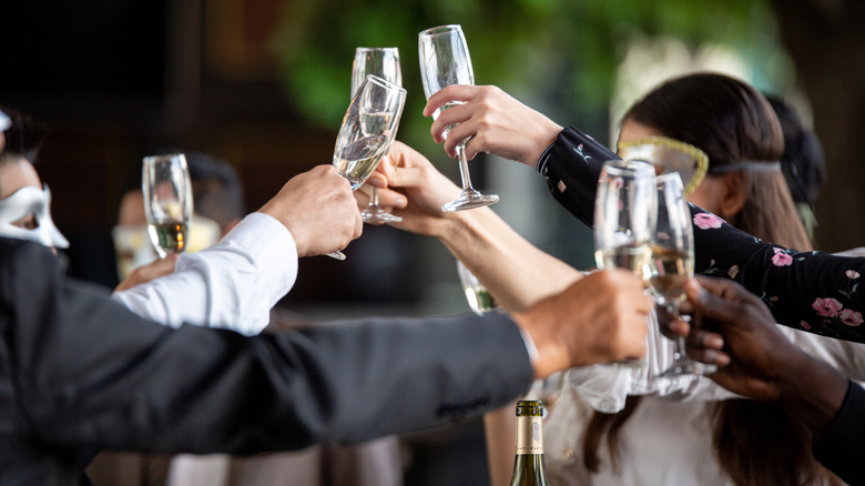 A group of people toasting champagne glasses
