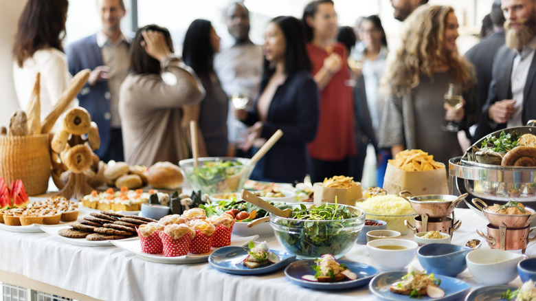 Food table in front of people mingling