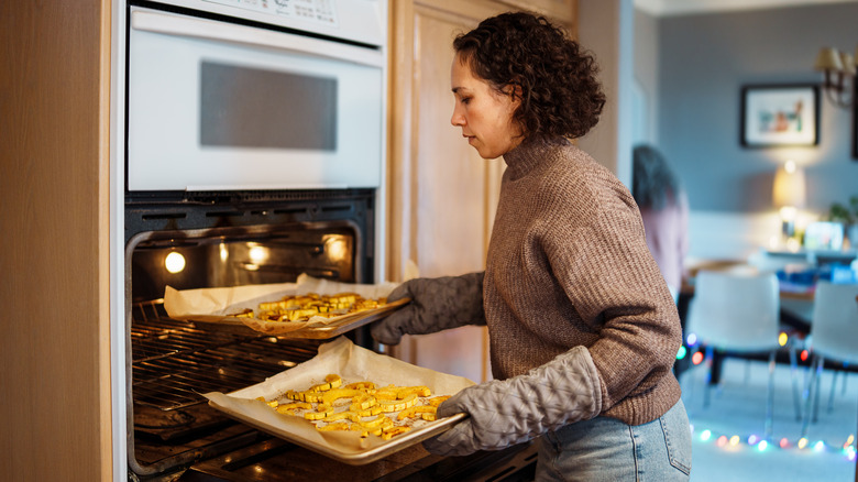 Person on a brown sweater baking food for gathering