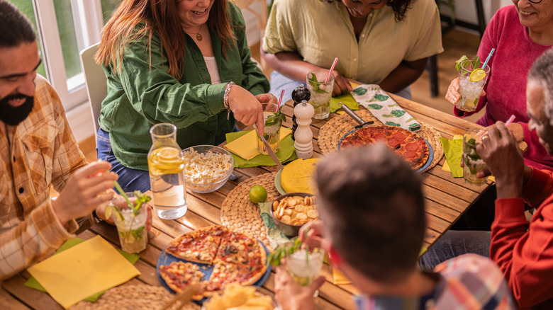 Group around a table eating and talking