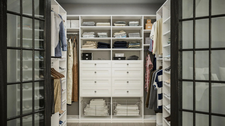 A custom white closet in a bedroom