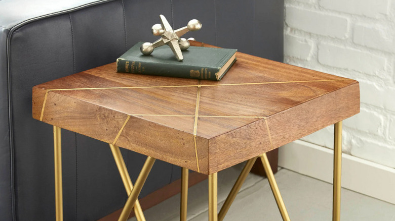 The Thane End Table with a book and paperweight placed on top