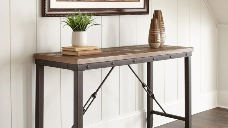 Plants, books, and ornamental pots on the Colton Sofa Table