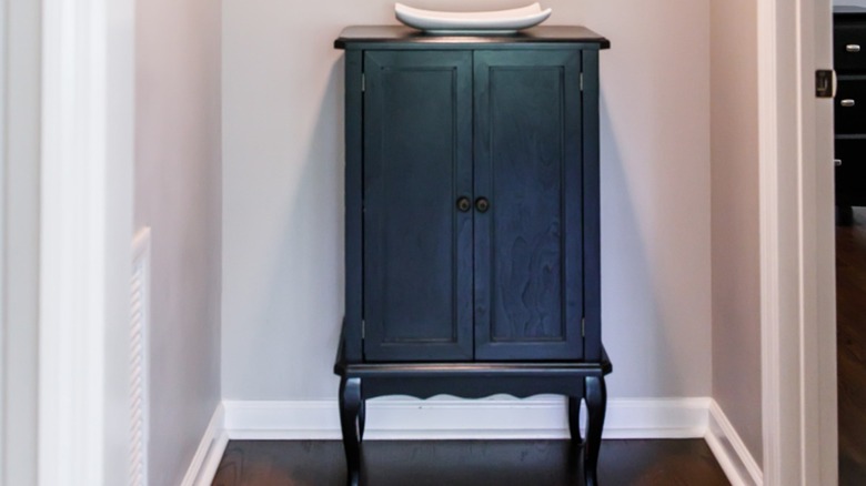Small cabinet at the end of a hallway