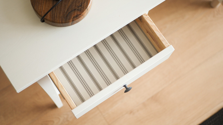 Opened drawer with decorative liner inside