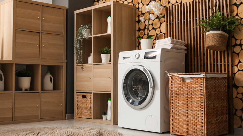 Laundry room with a washer and decor