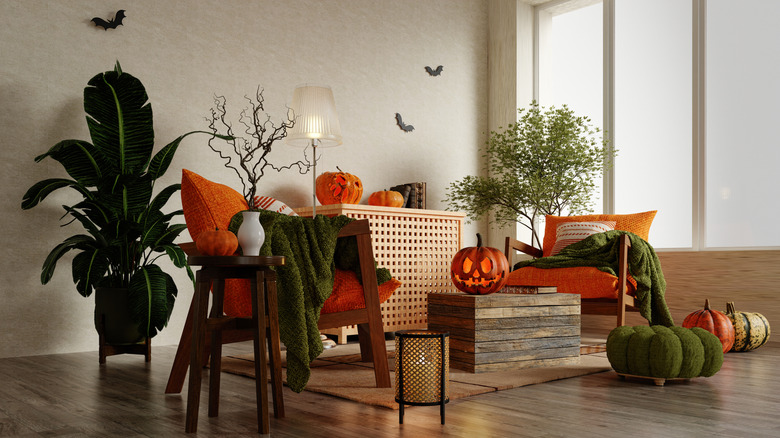 Indoor Halloween display with jack-o'-lanterns and pumpkin pillows
