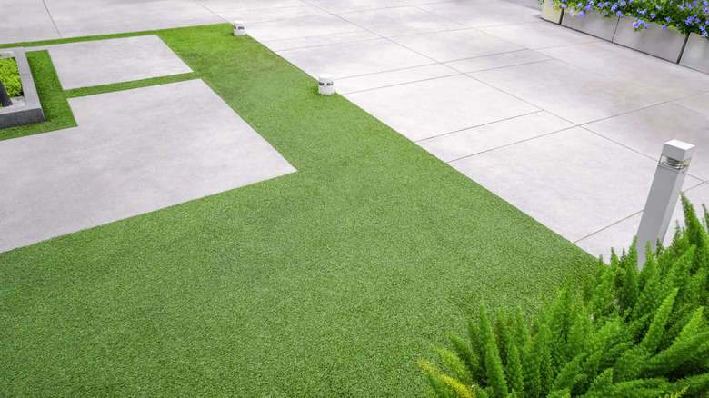 Artificial turf in a modern garden with marble tiles