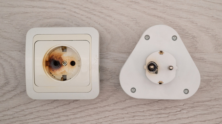 Close-up showing a burnt socket and plug