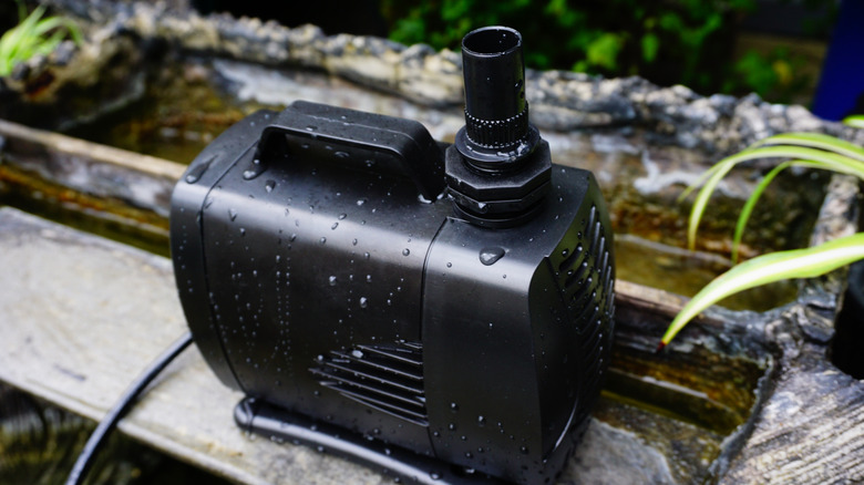 A pond pump removed from the water