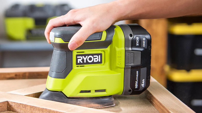 Close-up of someone sanding an awkward surface with Ryobi's 18V One+ Corner Cat Finish Sander