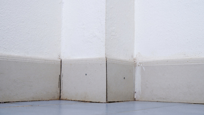 Baseboards lifting from a various corners of a room.
