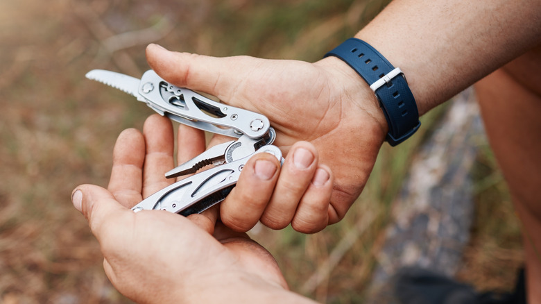 Close-up of a person holding a fold-out multi-tool