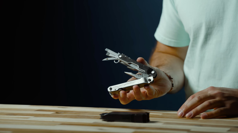 A person holding Leatherman's 19-in-1 Super Tool 300 Multi-Tool