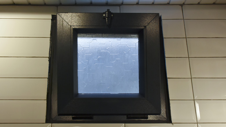 A small window fitted with a single pane of frosted glass