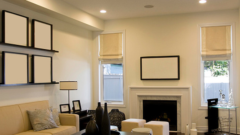 A living room with narrow windows fitted with Roman blinds