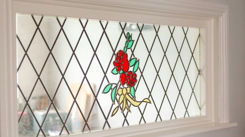 A small interior window with a stained glass pattern