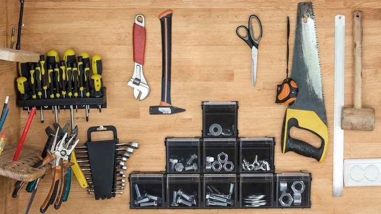 stacking bins filled with nuts and bolts on a workbench
