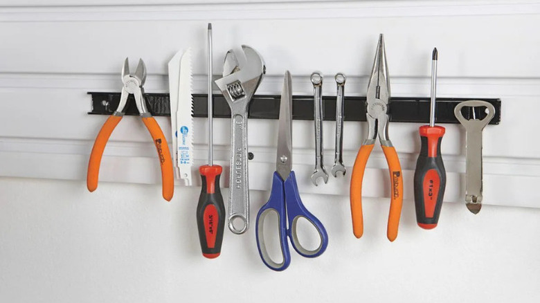 U.S. General's magnetic holder being used to hold various metal tools