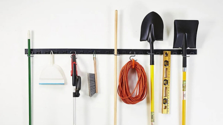 Various garden tools suspended from Yukon's multipurpose wall-mount tool hanger