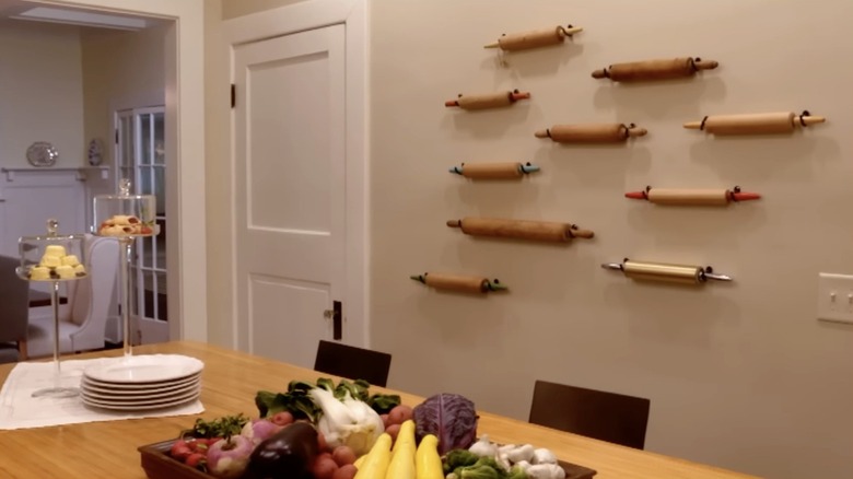 A kitchen wall with vintage rolling pins