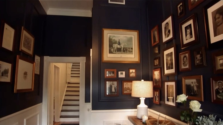 A black entryway with lots of family photos