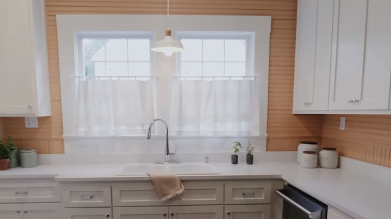 A rustic modern kitchen with peach beadboard