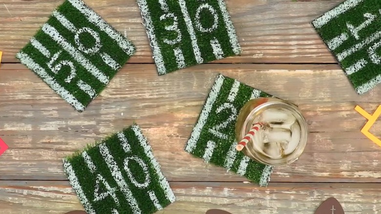 painted faux grass coasters on wooden table