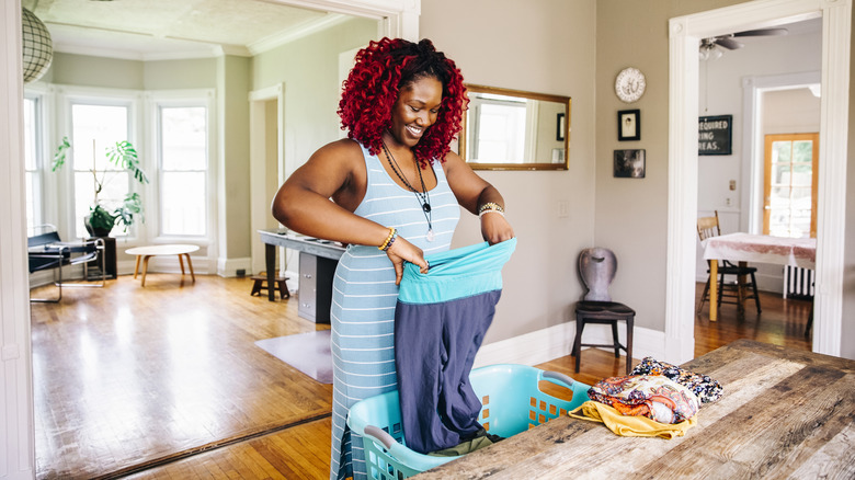 A woman folding laundry