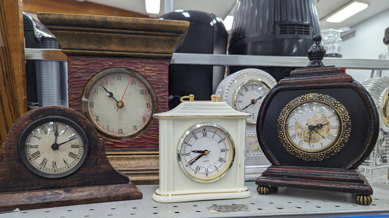 A collection of vintage clocks at a thrift store