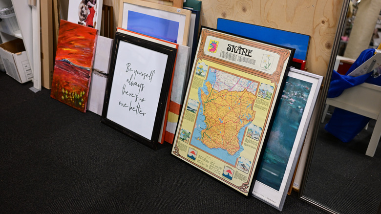 Maps and other art pieces for sale in a thrift store