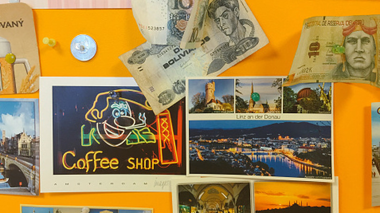 Close-up of a collage with various travel keepsakes, including money, beer mats, and postcards