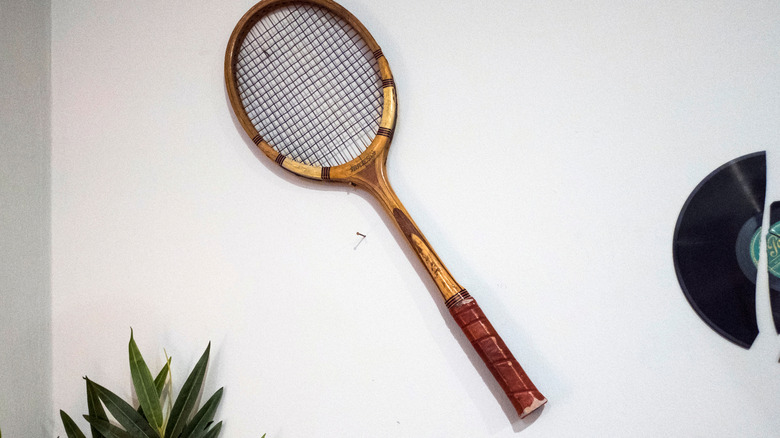 Shot of a vintage tennis racket hanging on an interior wall