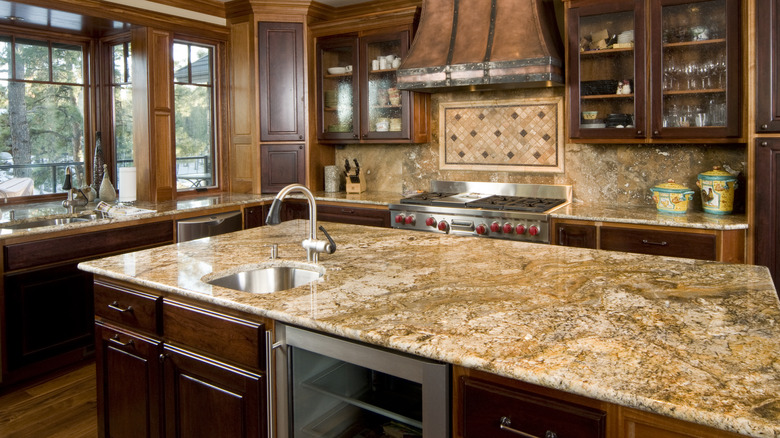 Kitchen featuring a granite island with sink
