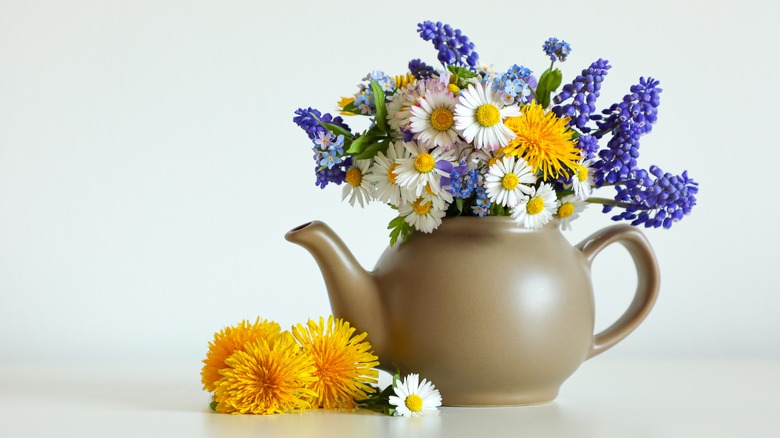 Teapot filled with a colorful bouquet