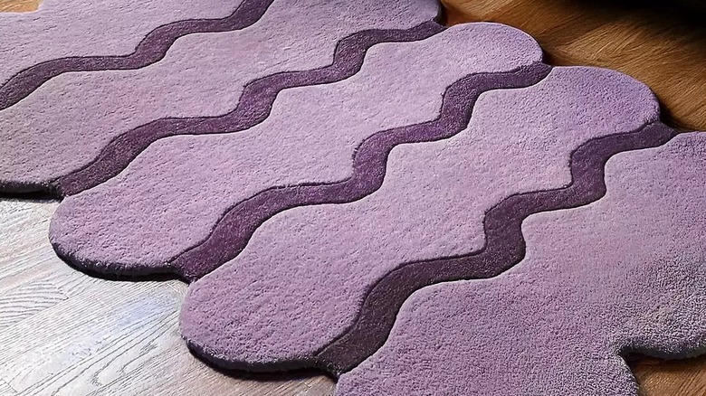 Purple amoeba rug on wood floor