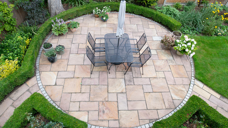 A neatly paved patio with dining area
