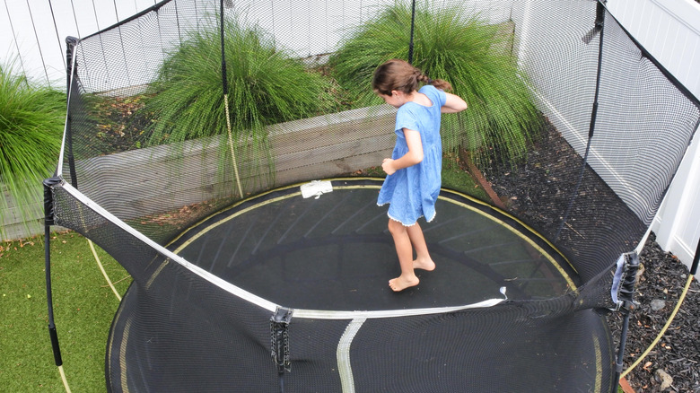 Girl jumping on trampoline